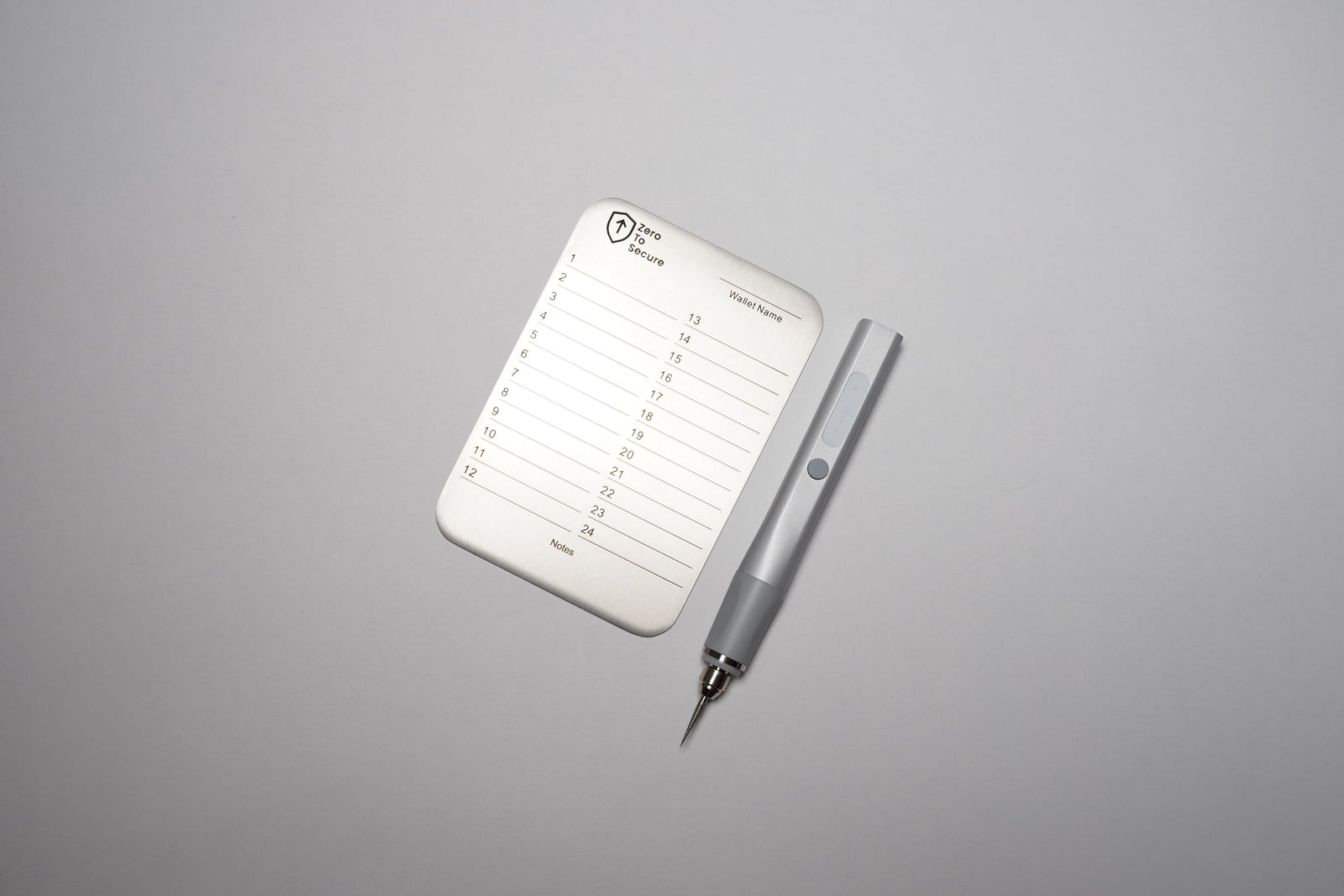 White notepad with pen on a gray background